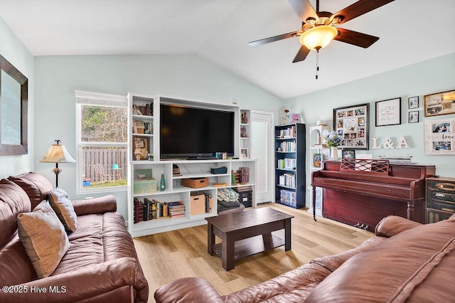 living area with vaulted ceiling, wood finished floors, and ceiling fan