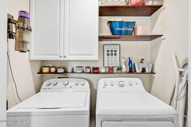 clothes washing area with cabinet space and separate washer and dryer