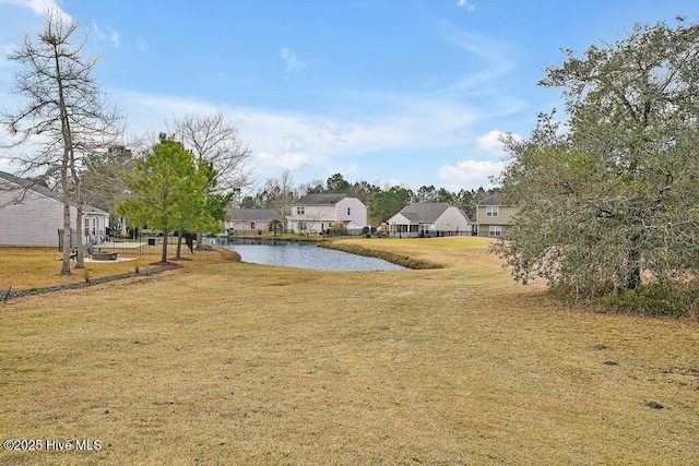 view of yard featuring a water view and a residential view
