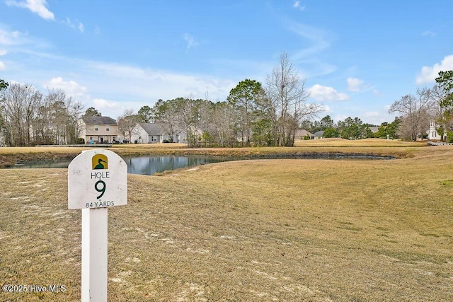 view of community featuring a water view and a lawn