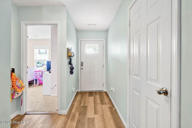 entrance foyer featuring visible vents, light wood-type flooring, and baseboards