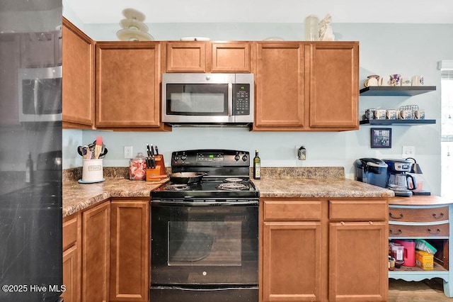 kitchen featuring stainless steel microwave, black electric range oven, refrigerator, and open shelves