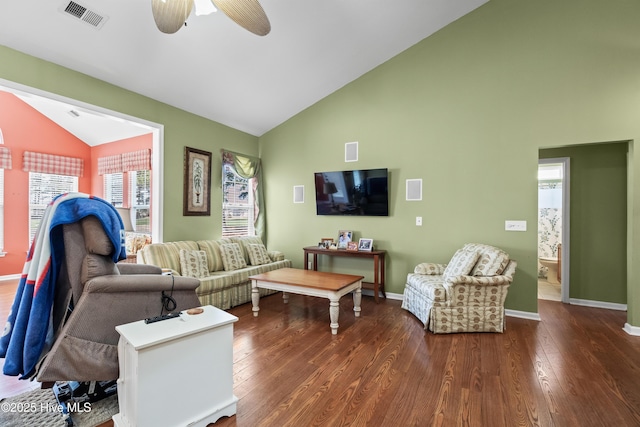 living area featuring visible vents, lofted ceiling, baseboards, and dark wood-style flooring