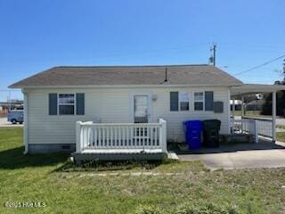 515 Mulberry St, Beaufort, NC 28516 - rear view of house with a yard, a carport, a wooden deck, and driveway