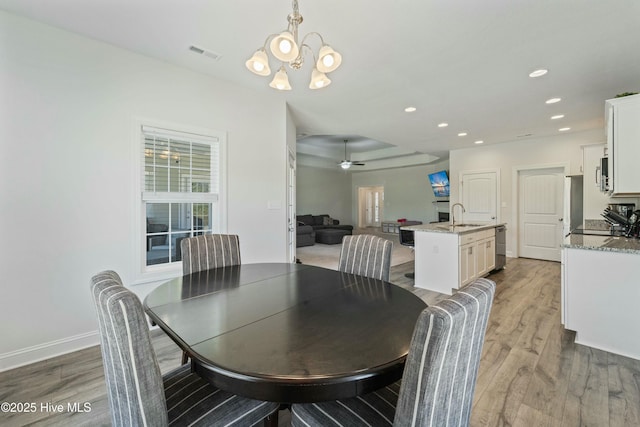 dining area featuring visible vents, ceiling fan with notable chandelier, wood finished floors, recessed lighting, and baseboards