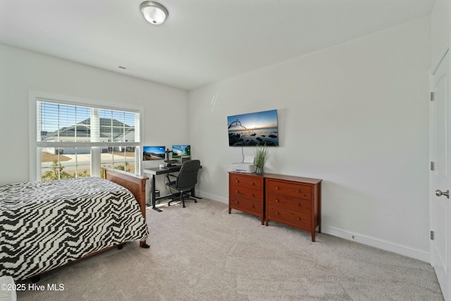 carpeted bedroom with visible vents and baseboards