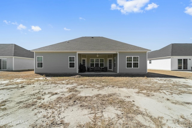 back of house with a patio, ceiling fan, and roof with shingles