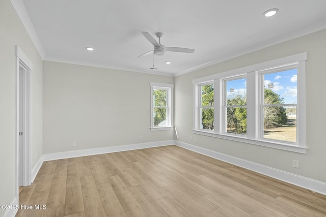 spare room with recessed lighting, light wood-style flooring, baseboards, and ornamental molding