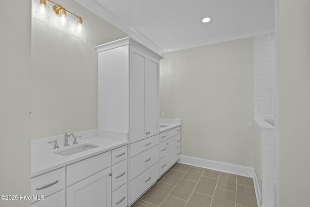 bathroom featuring baseboards, double vanity, a sink, tile patterned floors, and a bath