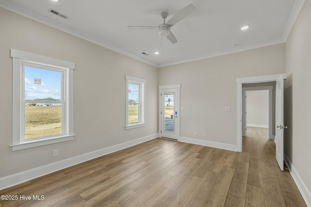 spare room featuring recessed lighting, wood finished floors, visible vents, and baseboards