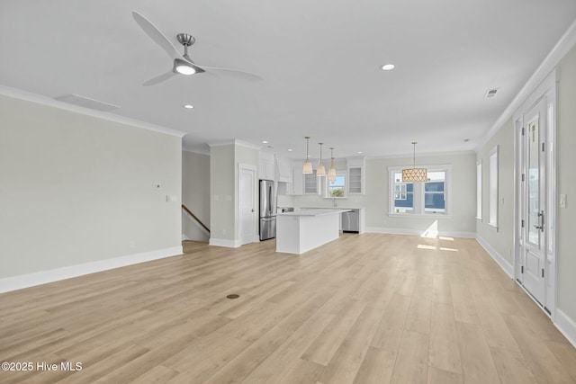 unfurnished living room featuring light wood-type flooring, baseboards, visible vents, and ornamental molding