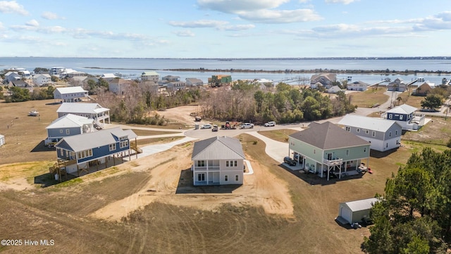 bird's eye view with a residential view and a water view