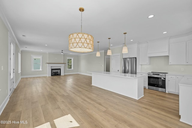 kitchen with premium range hood, light wood-type flooring, a center island, recessed lighting, and appliances with stainless steel finishes