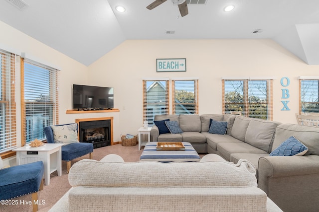 carpeted living room featuring lofted ceiling, a fireplace, and visible vents