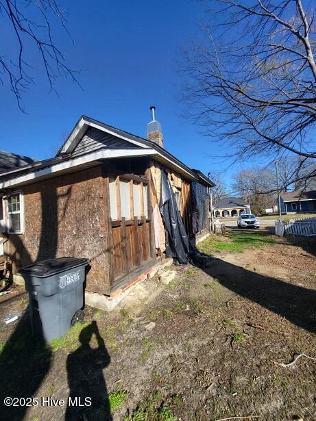 view of side of property with a chimney