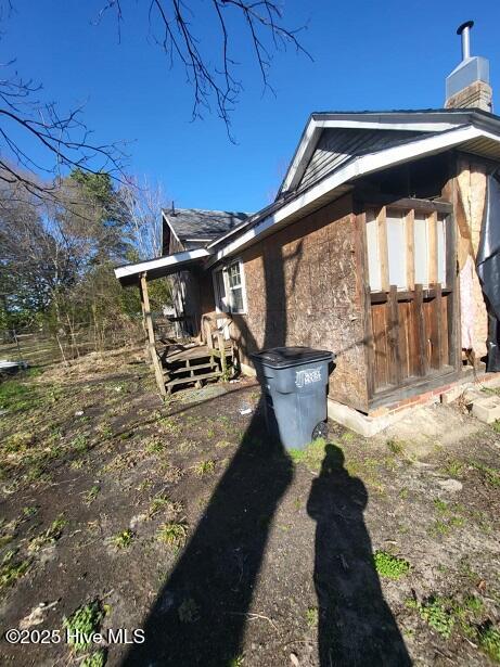 view of property exterior featuring a chimney