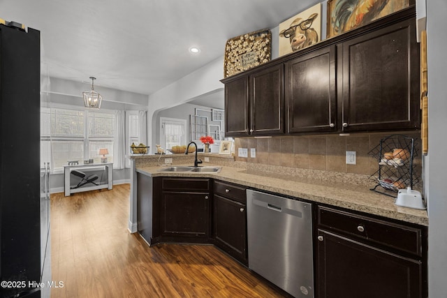 kitchen with a sink, dark wood-type flooring, dark brown cabinets, dishwasher, and backsplash