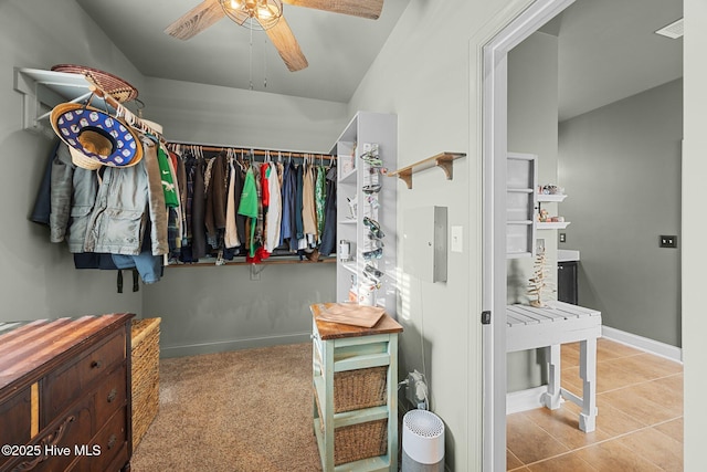 spacious closet featuring carpet, ceiling fan, and tile patterned flooring