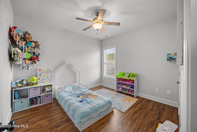 bedroom featuring ceiling fan, baseboards, and wood finished floors