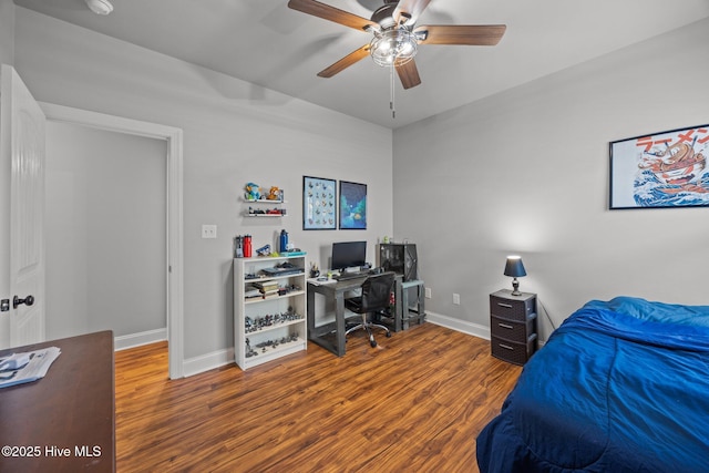 bedroom with a ceiling fan, baseboards, and wood finished floors