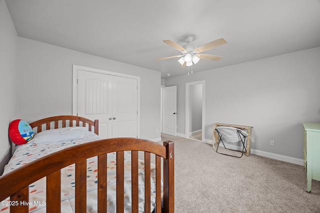 bedroom featuring baseboards, carpet floors, a closet, and a ceiling fan