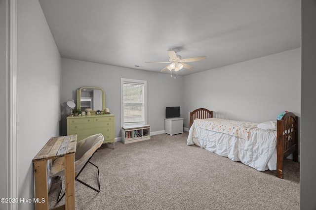 carpeted bedroom featuring baseboards and ceiling fan