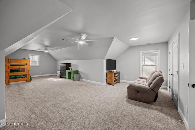 sitting room with baseboards, carpet, and lofted ceiling