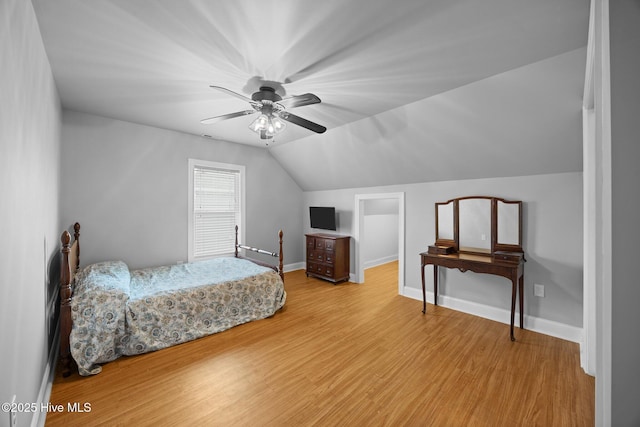 bedroom with lofted ceiling, wood finished floors, baseboards, and ceiling fan