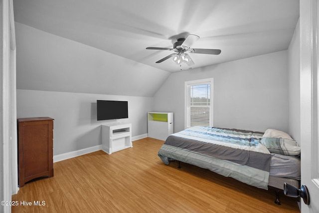 bedroom with ceiling fan, baseboards, lofted ceiling, and wood finished floors