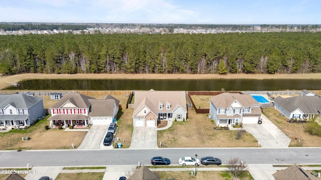 bird's eye view featuring a wooded view and a residential view