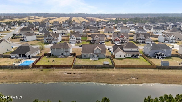 drone / aerial view featuring a residential view and a water view