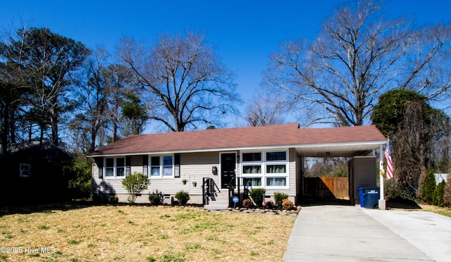 ranch-style home featuring a front yard, a carport, driveway, and crawl space