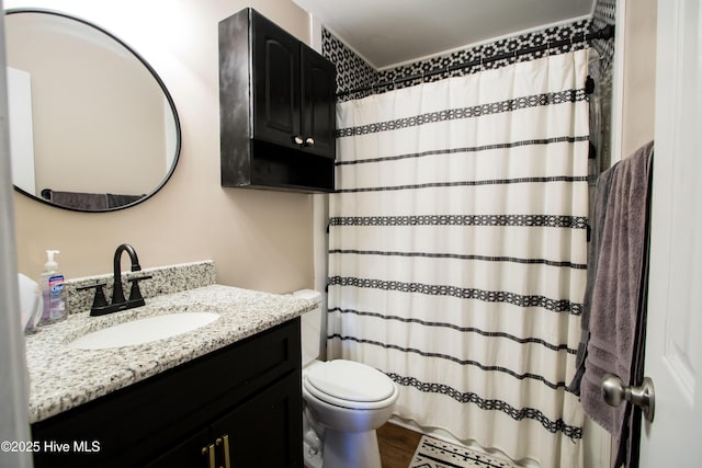 full bathroom featuring vanity, a shower with shower curtain, and toilet