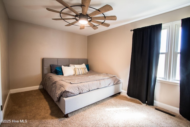 carpeted bedroom featuring a ceiling fan, baseboards, and visible vents