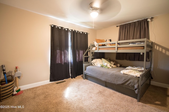 bedroom with baseboards, visible vents, and ceiling fan