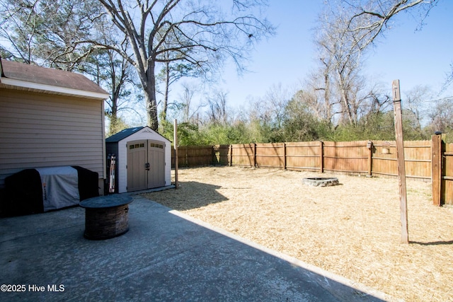 view of yard with a fenced backyard, a shed, a patio area, and an outdoor structure