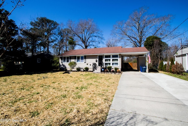 single story home with a carport, concrete driveway, and a front yard