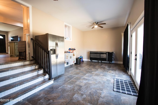 interior space featuring stairs, baseboards, and ceiling fan