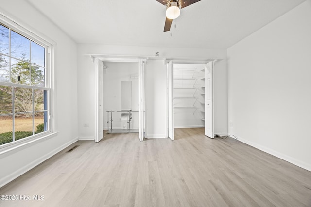 unfurnished bedroom with visible vents, a closet, light wood-style floors, baseboards, and ceiling fan