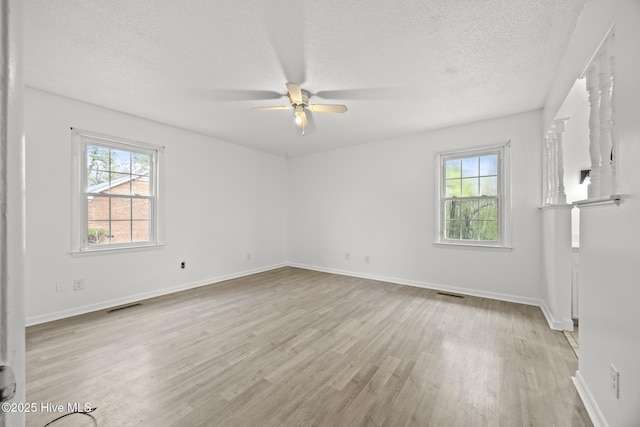 unfurnished room featuring visible vents, baseboards, and light wood finished floors