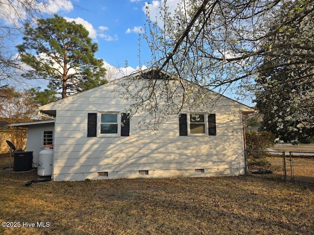 view of property exterior featuring crawl space, central AC unit, and fence