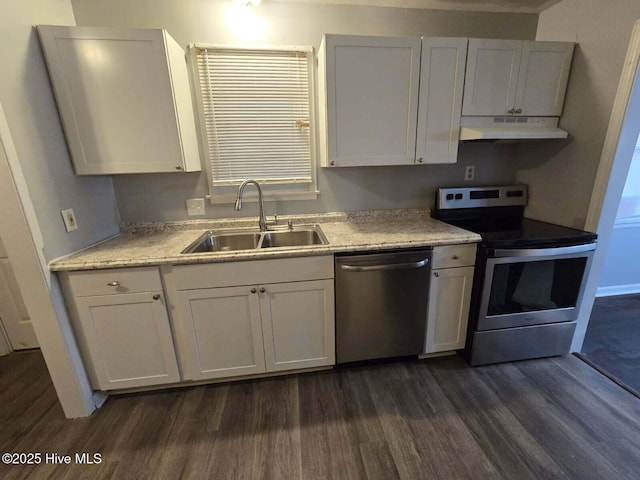 kitchen with a sink, appliances with stainless steel finishes, dark wood finished floors, and under cabinet range hood