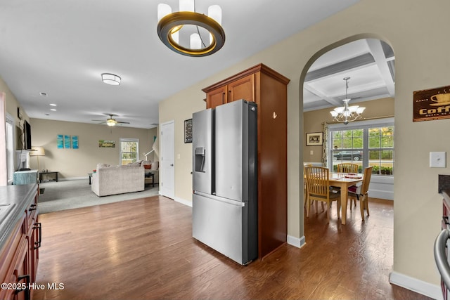 kitchen with dark wood-type flooring, a healthy amount of sunlight, stainless steel fridge with ice dispenser, and coffered ceiling