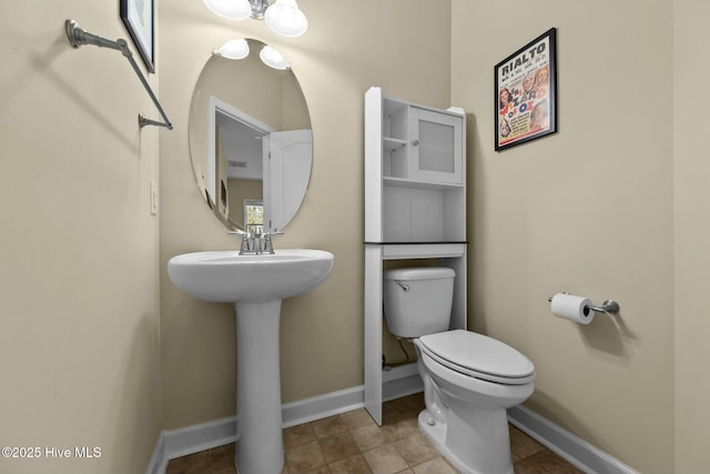 bathroom with tile patterned flooring, visible vents, toilet, and baseboards