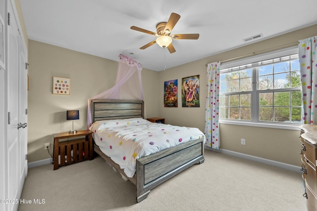 bedroom featuring visible vents, a ceiling fan, baseboards, and carpet floors