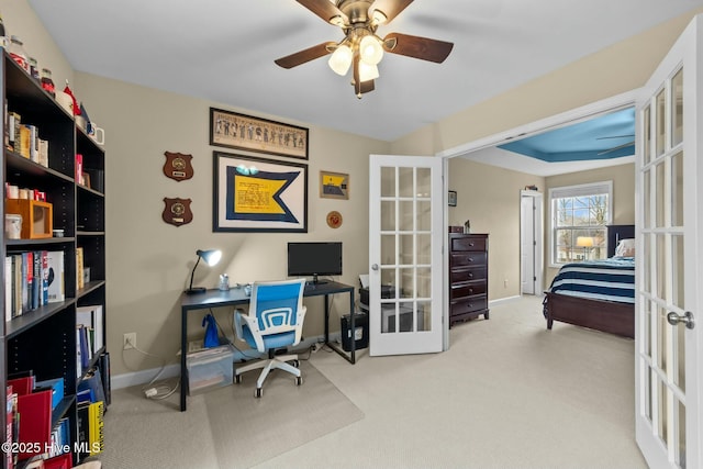 home office featuring carpet flooring, ceiling fan, french doors, and baseboards