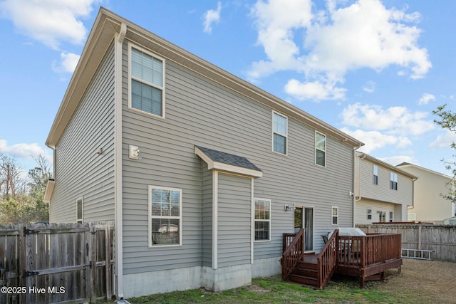 back of house featuring a fenced backyard and a deck