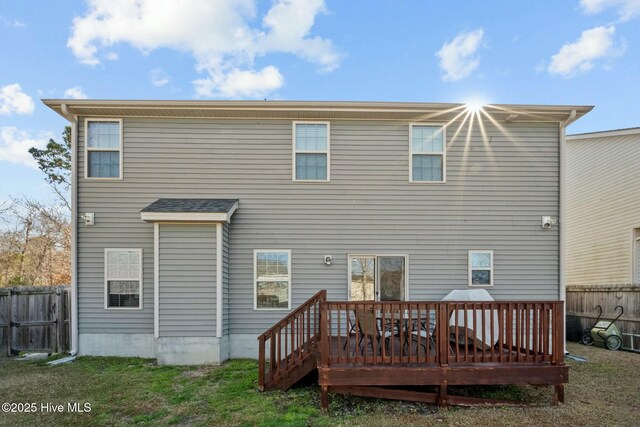 rear view of property featuring fence and a wooden deck