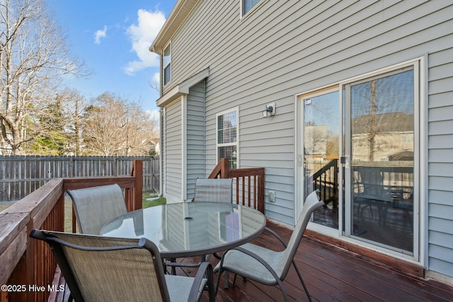 wooden terrace featuring outdoor dining space and fence