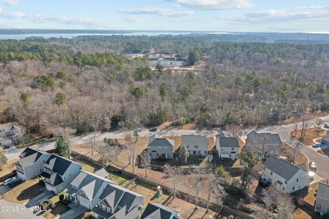 birds eye view of property with a residential view and a wooded view